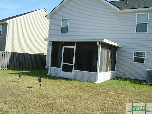 12 Noble Jones Ct, Port Wentworth, GA 31407 - rear view of house with fence, a yard, a sunroom, and roof with shingles
