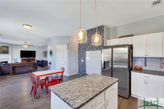 53 Boykin Way NE, Ludowici, GA 31316 - kitchen with stainless steel refrigerator with ice dispenser, ceiling fan, visible vents, and light stone counters