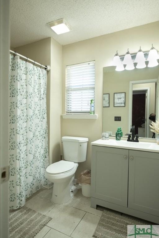 350 Clark St, Richmond Hill, GA 31324 - bathroom with vanity, tile patterned flooring, a textured ceiling, curtained shower, and toilet