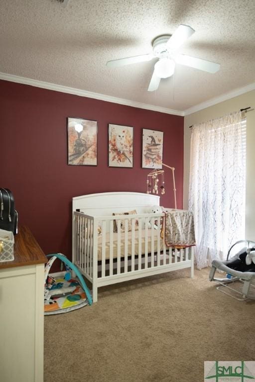350 Clark St, Richmond Hill, GA 31324 - carpeted bedroom featuring a crib, a textured ceiling, ceiling fan, and crown molding