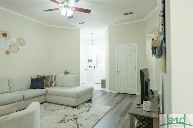 350 Clark St, Richmond Hill, GA 31324 - living room with visible vents, ceiling fan with notable chandelier, wood finished floors, and ornamental molding