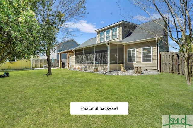 back of house featuring a sunroom, a yard, and a fenced backyard
