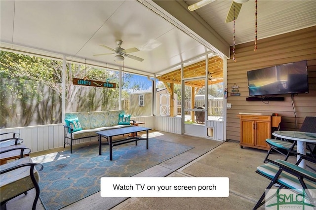 sunroom / solarium with ceiling fan and an outdoor living space
