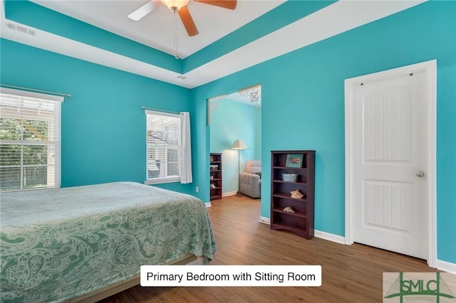 bedroom featuring visible vents, wood finished floors, and baseboards