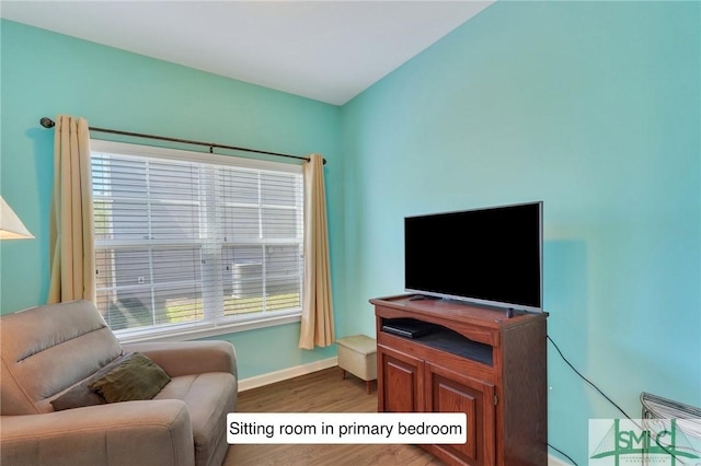 living area featuring wood finished floors and baseboards