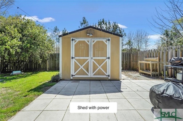 view of shed with a fenced backyard
