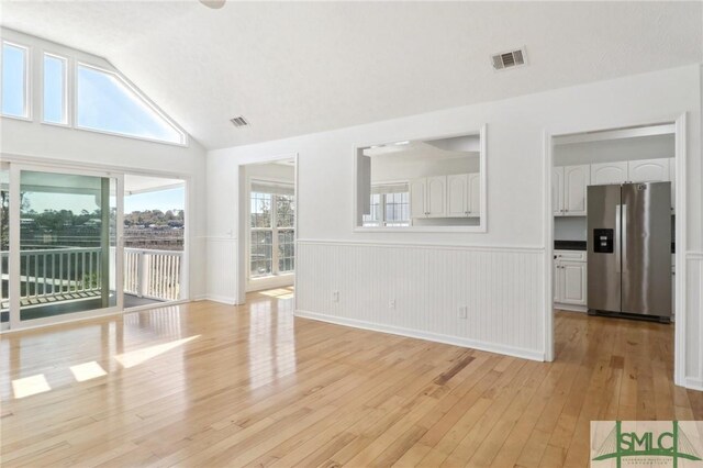 141 Runner Rd, Savannah, GA 31410 - unfurnished room featuring light wood-type flooring, wainscoting, and lofted ceiling