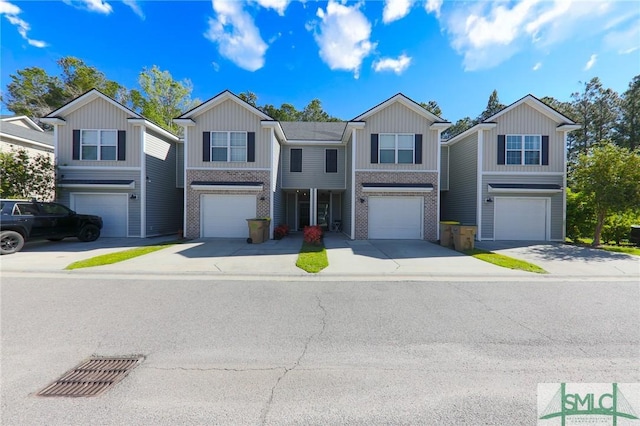 30 Walker Ct, Richmond Hill, GA 31324 - view of front of home with board and batten siding, an attached garage, and brick siding