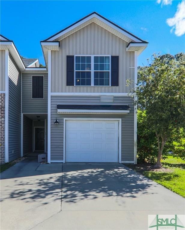 30 Walker Ct, Richmond Hill, GA 31324 - traditional home featuring an attached garage, board and batten siding, and concrete driveway