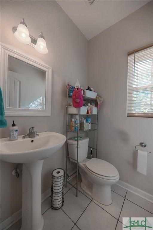 30 Walker Ct, Richmond Hill, GA 31324 - bathroom with toilet, a sink, tile patterned floors, and baseboards