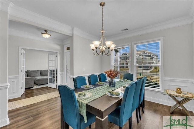 52 Shoefstall St, Port Wentworth, GA 31407 - dining area with crown molding, a chandelier, a wainscoted wall, visible vents, and wood finished floors