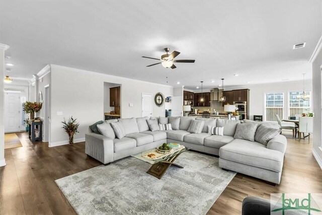 52 Shoefstall St, Port Wentworth, GA 31407 - living room with crown molding, baseboards, dark wood-style floors, visible vents, and a ceiling fan