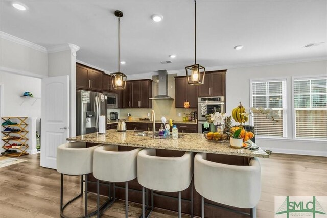 52 Shoefstall St, Port Wentworth, GA 31407 - kitchen featuring crown molding, wood finished floors, wall chimney exhaust hood, appliances with stainless steel finishes, and dark brown cabinetry