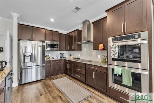 52 Shoefstall St, Port Wentworth, GA 31407 - kitchen featuring visible vents, light stone countertops, wall chimney exhaust hood, tasteful backsplash, and appliances with stainless steel finishes