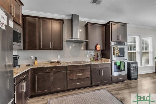 52 Shoefstall St, Port Wentworth, GA 31407 - kitchen with appliances with stainless steel finishes, beverage cooler, wall chimney range hood, visible vents, and ornamental molding
