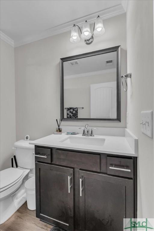 52 Shoefstall St, Port Wentworth, GA 31407 - bathroom featuring wood finished floors, crown molding, toilet, and vanity