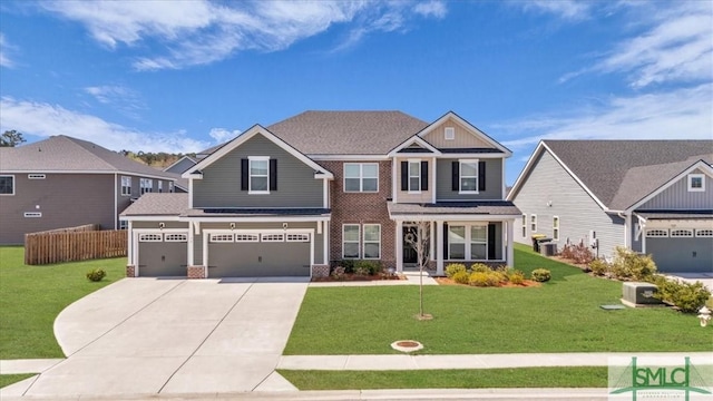 52 Shoefstall St, Port Wentworth, GA 31407 - craftsman-style home with a front yard, brick siding, concrete driveway, and an attached garage