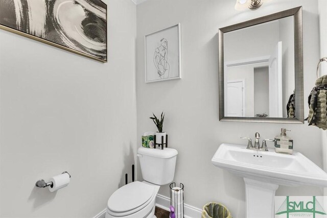 52 Shoefstall St, Port Wentworth, GA 31407 - half bathroom with baseboards, toilet, and a sink