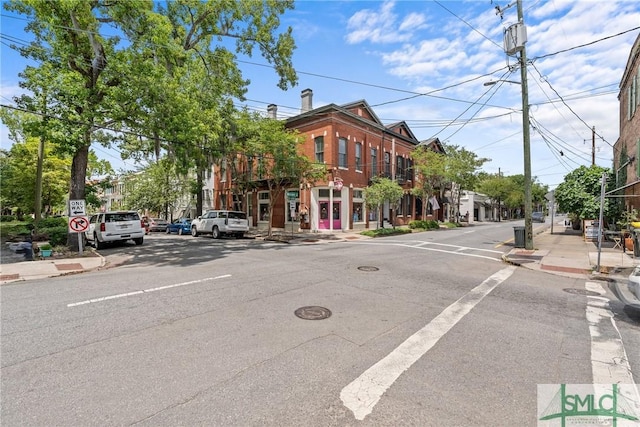 417 Whitaker St, Savannah, GA 31401 - view of asphalt road featuring sidewalks, curbs, street lighting, and traffic signs