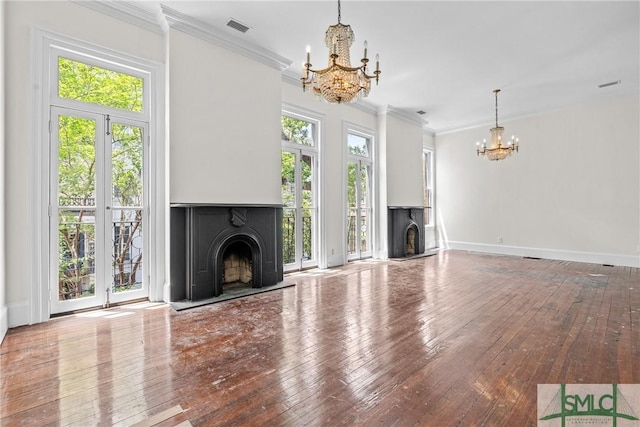 417 Whitaker St, Savannah, GA 31401 - unfurnished living room featuring a fireplace with raised hearth, a chandelier, wood-type flooring, ornamental molding, and baseboards