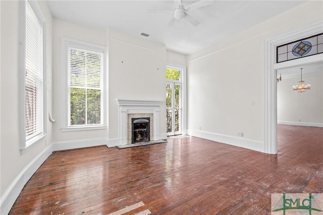 417 Whitaker St, Savannah, GA 31401 - unfurnished living room featuring hardwood / wood-style floors, a tiled fireplace, ceiling fan, baseboards, and a chandelier