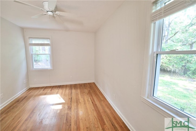 unfurnished room with ceiling fan, light wood-type flooring, and baseboards