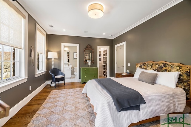5091/2 Tattnall St, Savannah, GA 31401 - bedroom featuring wood finished floors, a spacious closet, baseboards, visible vents, and ornamental molding