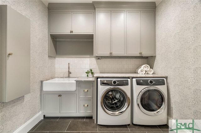 5091/2 Tattnall St, Savannah, GA 31401 - laundry area with cabinet space, dark tile patterned flooring, a sink, and separate washer and dryer