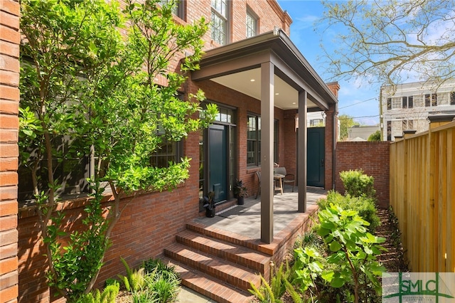 5091/2 Tattnall St, Savannah, GA 31401 - entrance to property with brick siding, a porch, and fence
