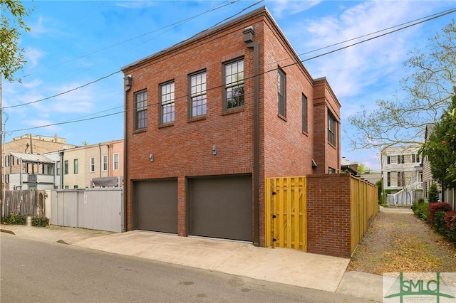 5091/2 Tattnall St, Savannah, GA 31401 - view of property with driveway, a garage, and fence