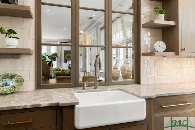 5091/2 Tattnall St, Savannah, GA 31401 - kitchen featuring a sink, tasteful backsplash, light stone counters, and open shelves