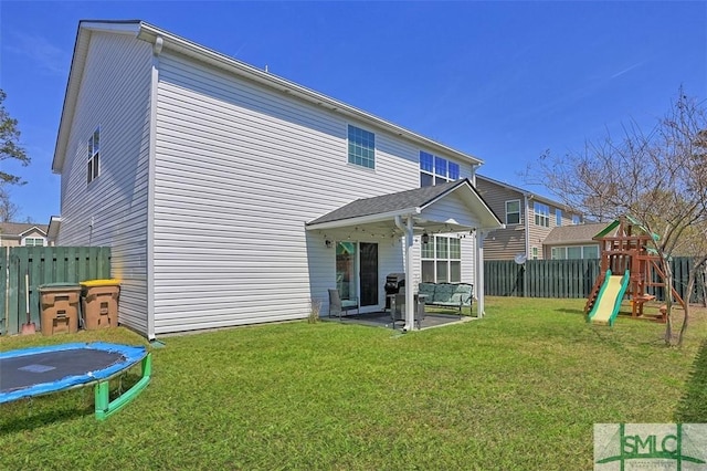 95 Glen Way, Richmond Hill, GA 31324 - back of property featuring a trampoline, a patio, and a playground