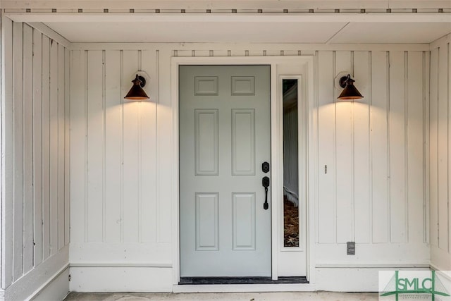 property entrance featuring board and batten siding