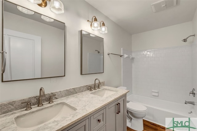 bathroom with toilet, shower / bathtub combination, a sink, and visible vents