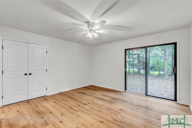 unfurnished bedroom with baseboards, access to exterior, and light wood-style floors