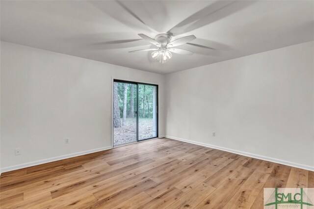 empty room featuring a ceiling fan, baseboards, and light wood-style flooring