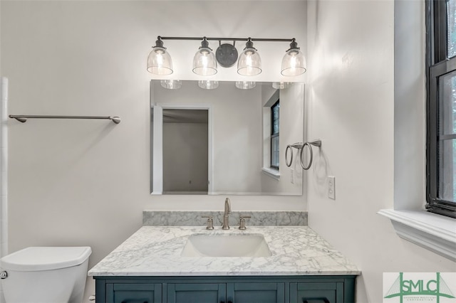 bathroom featuring toilet and vanity