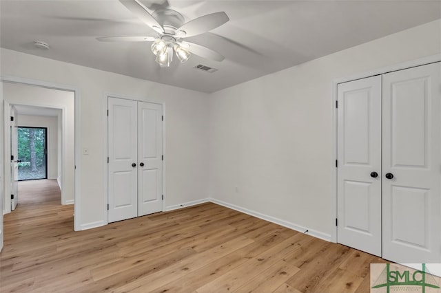 unfurnished bedroom featuring baseboards, a ceiling fan, visible vents, and light wood-type flooring