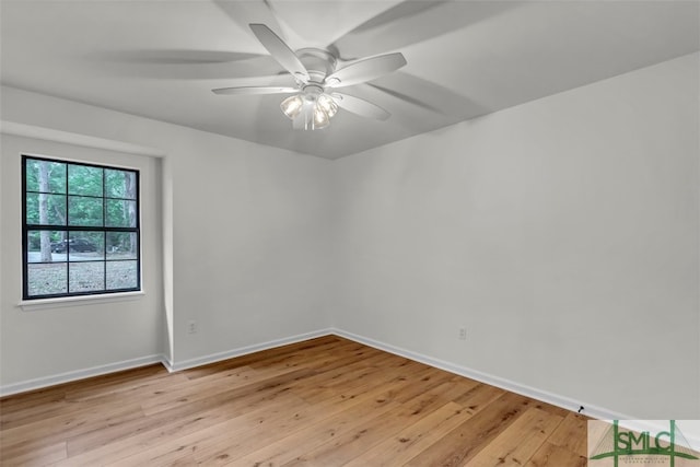 spare room with ceiling fan, baseboards, and light wood-type flooring