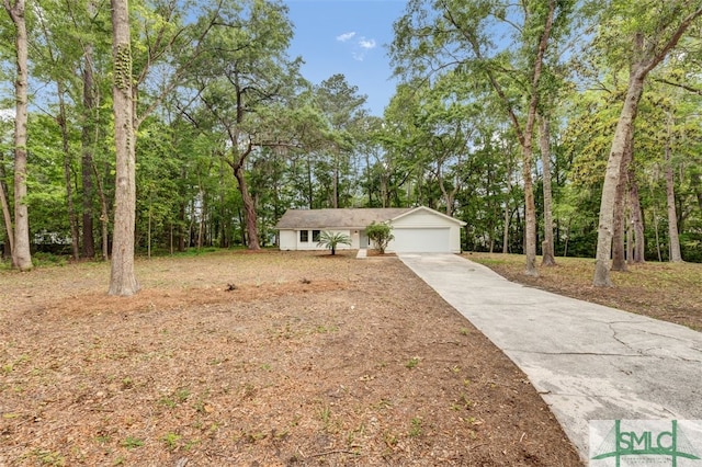 ranch-style home featuring an attached garage and driveway