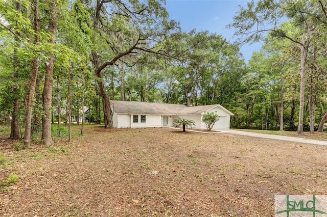 ranch-style house with an attached garage and driveway