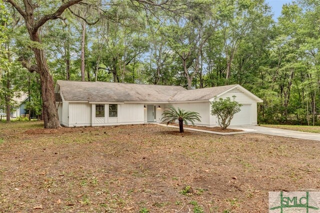 single story home featuring a garage and driveway