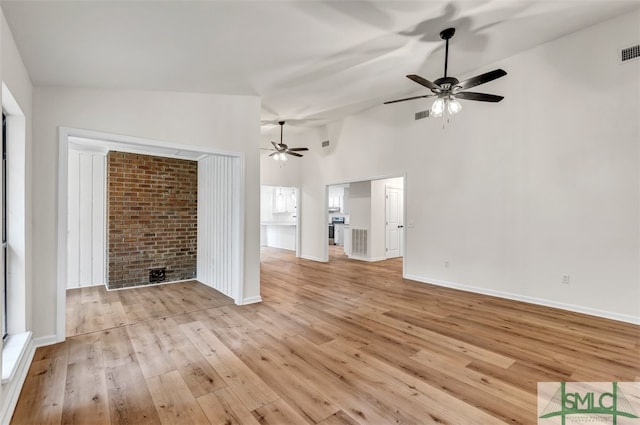 unfurnished living room with baseboards, light wood-style flooring, visible vents, and ceiling fan