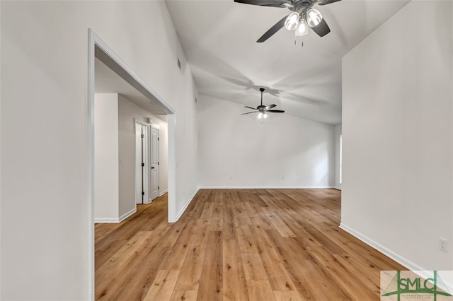 spare room with light wood-type flooring, baseboards, and ceiling fan