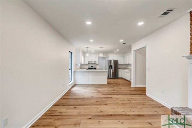 interior space featuring light wood-type flooring, visible vents, and recessed lighting