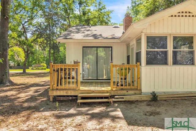 exterior space with a wooden deck and a chimney