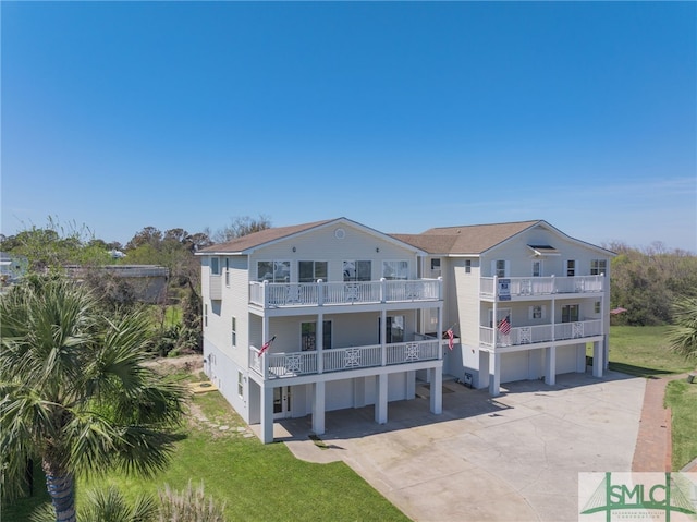 view of property with concrete driveway and a garage