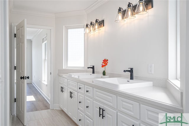 full bath featuring double vanity, a sink, and ornamental molding