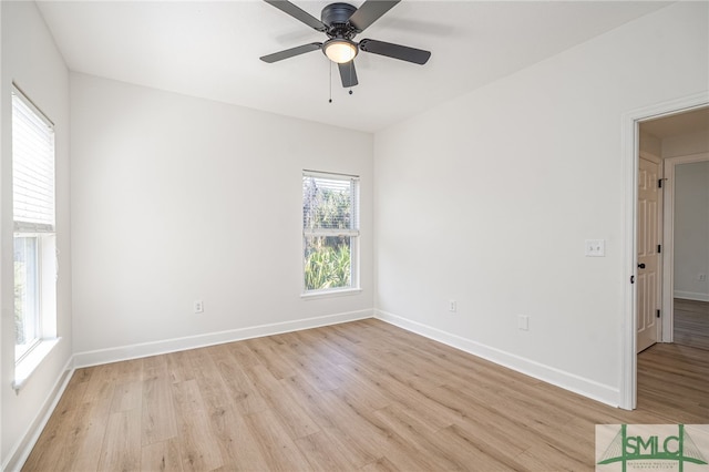 unfurnished room featuring baseboards, a ceiling fan, and light wood-style floors