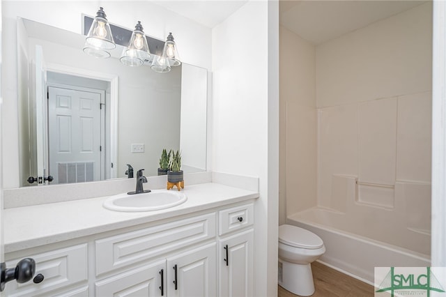 full bath with toilet, vanity, wood finished floors, and tub / shower combination